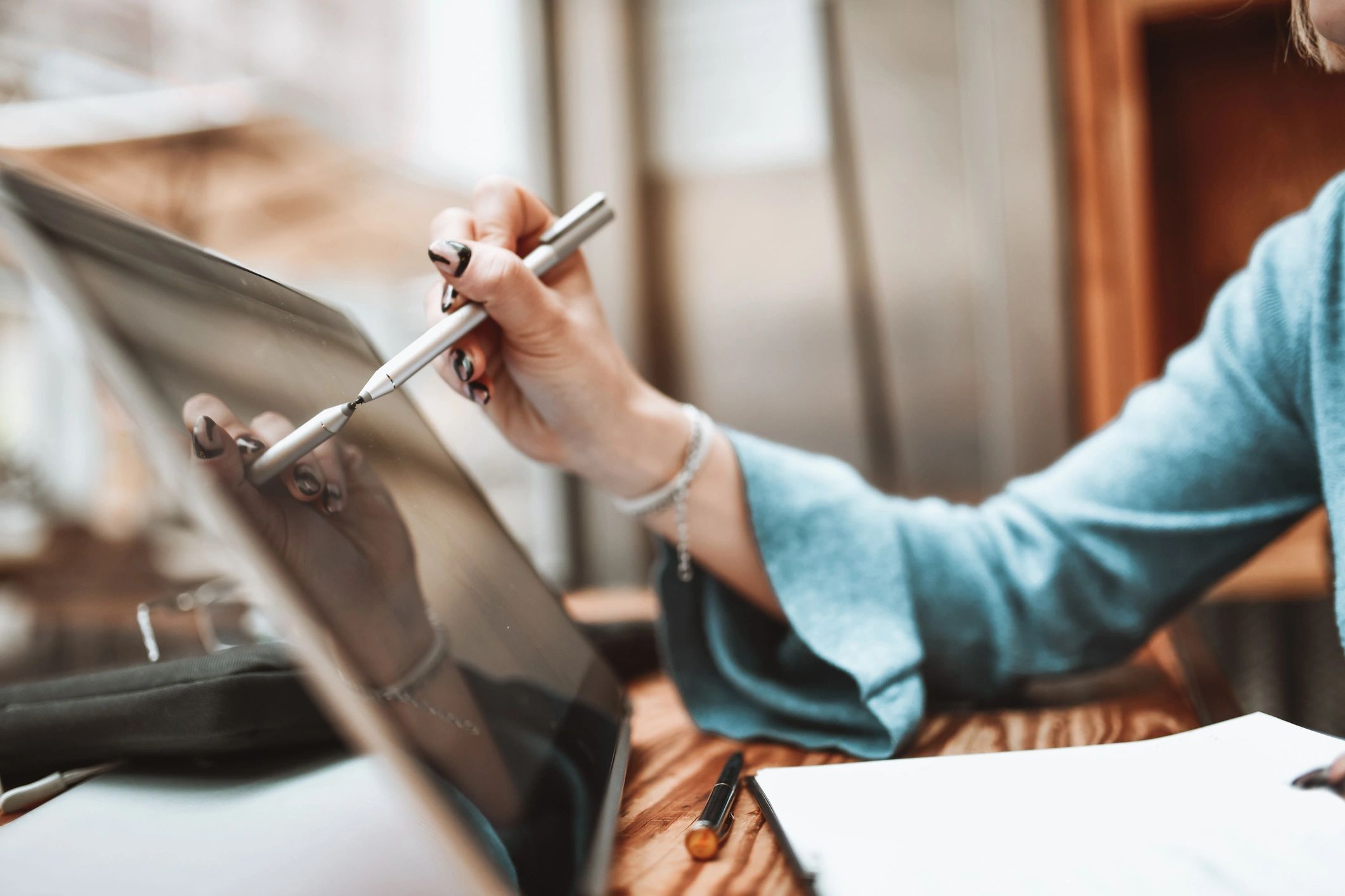 Designer working on a laptop with stylus