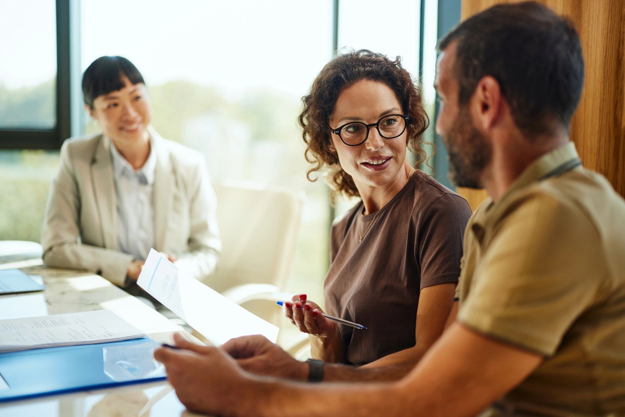 Couple discussing a plan with an advisor in an office